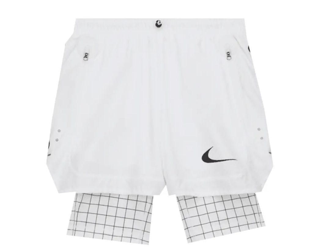Nike x Off-White Shorts 'White' with a layered grid-pattern compression underlayer and black Swoosh logo, photographed against a white background